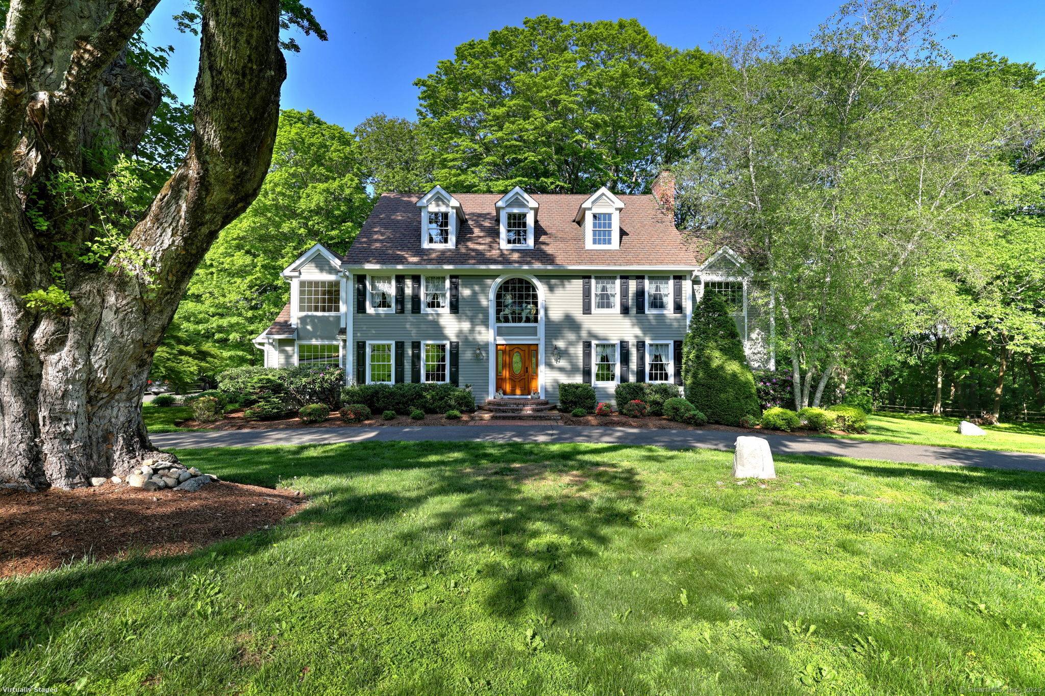 A long and winding drive leads to this exceptional colonial sited under a grand old oak tree.