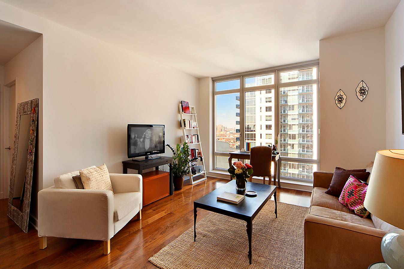 1 bedroom, 1 bathroom residence with floor to ceiling windows showcasing twilight views of the striking Manhattan skyline.