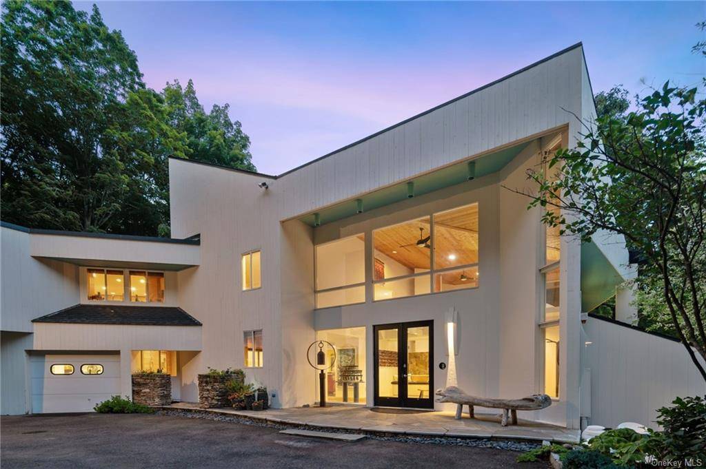 Stunning Vuko Tashkovich contemporary design abutting 25 acres of watershed land in a private Pound Ridge locale.