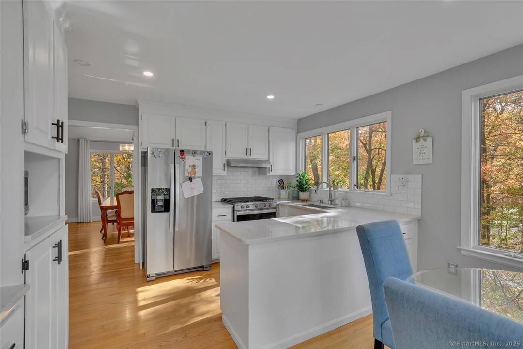 Experience ultimate privacy and tranquility in this beautifully landscaped home, set on a secluded rear lot with a wooded backdrop.