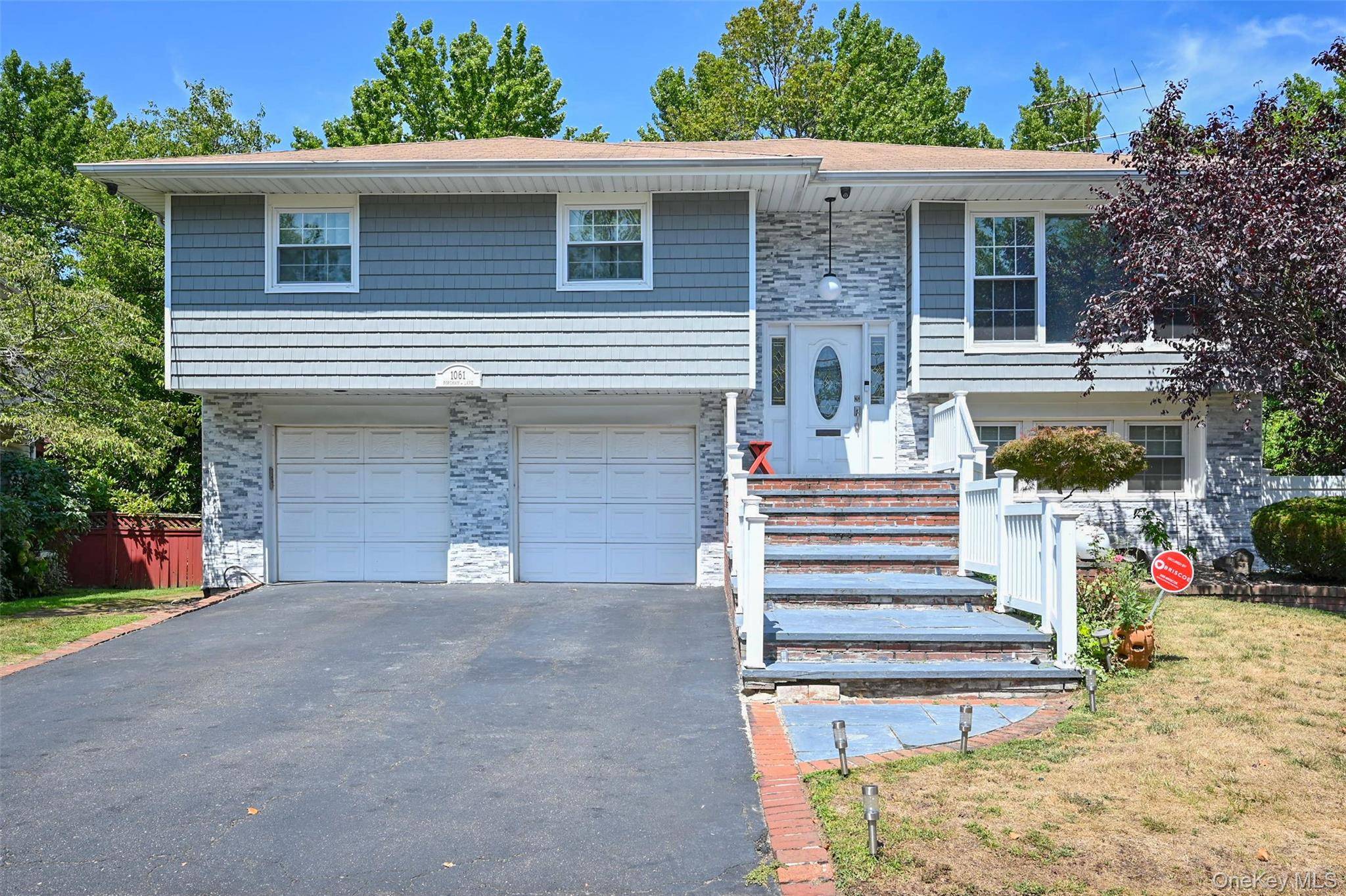 Sun drenched, oversized Hi Ranch in Woodmere ideal for extended family or true mother daughter living.