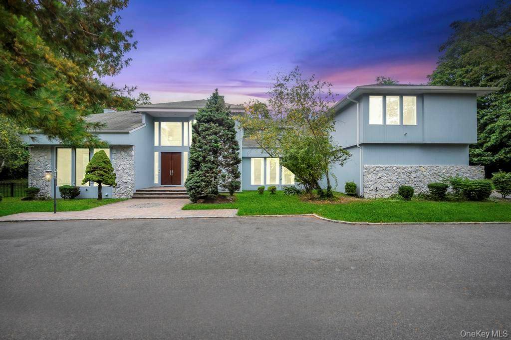Welcome to this Magnificent Contemporary Center Hall Colonial in a Gated Community on 2 Acres of landscaped and Tree lined Property.