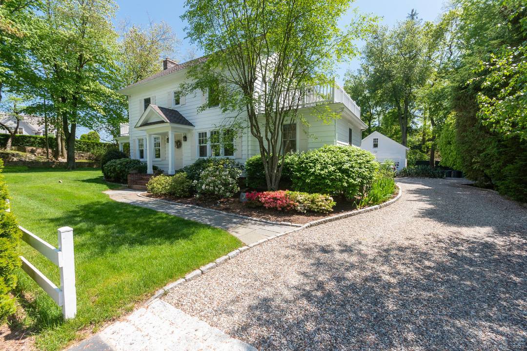 Nestled down on one of Darien's most sought after streets, this charming farmhouse offers five bedrooms, three full one half bath, and lots of privacy.