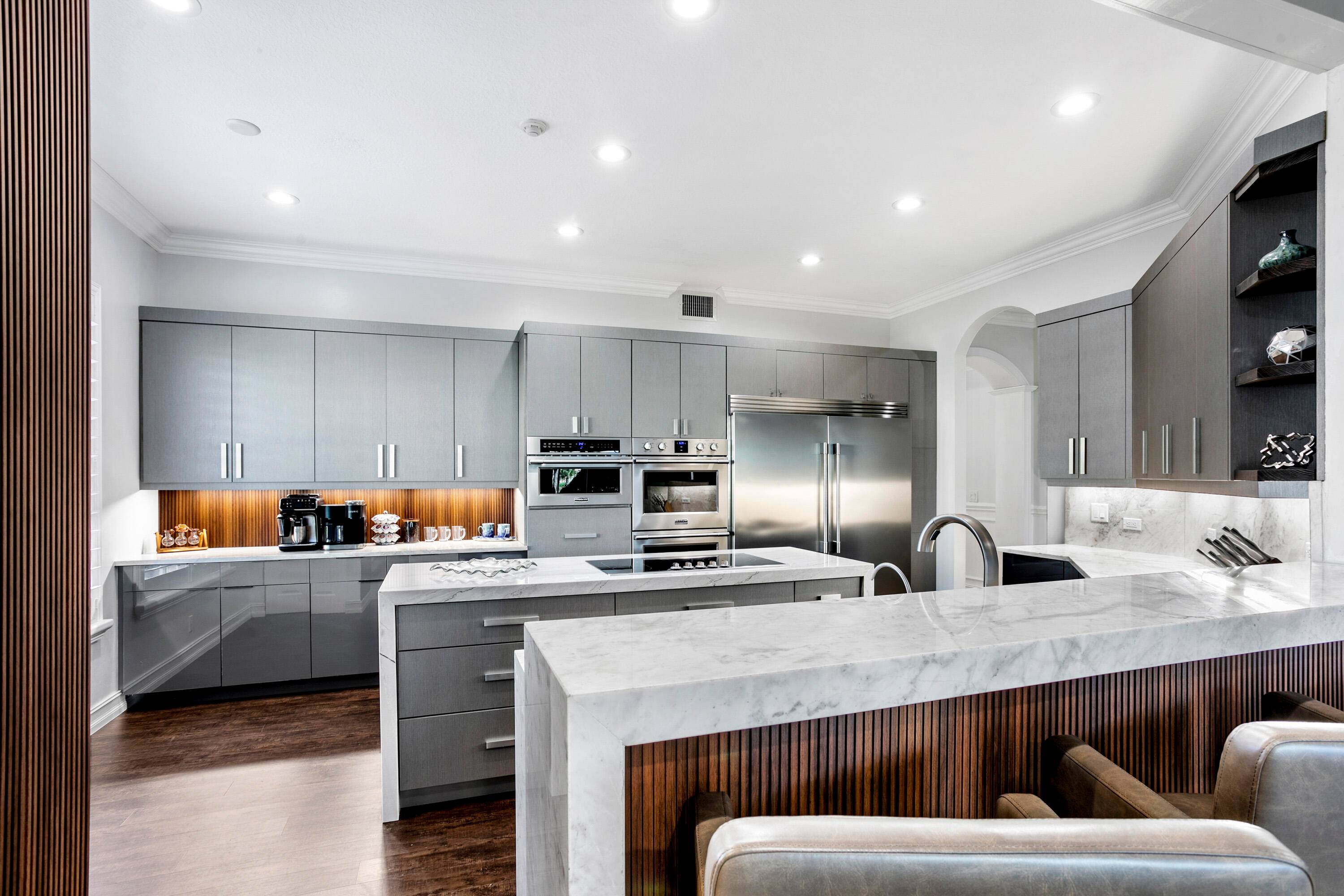Spectacular golf course view and a fully renovated custom kitchen make this first floor luxury condo with impact windows a special find.