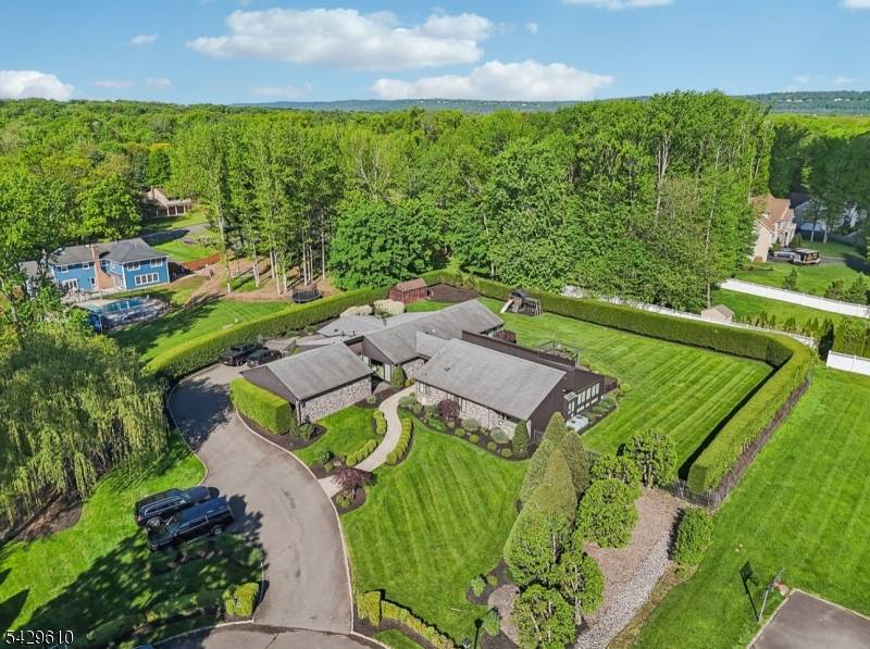 Welcome to this sprawling Custom Ranch offering exceptional privacy and luxury on just over an acre of lush, professionally landscaped property.
