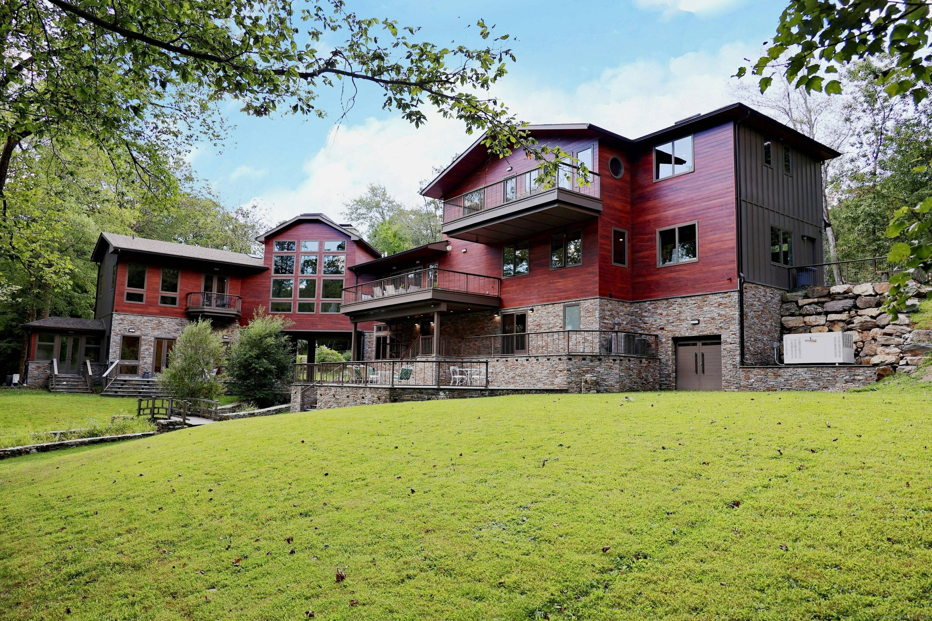 Architecturally significant modern home, influenced by the works of Frank Lloyd Wright Philip Johnson, nestled privately on 2 acres at the end of a cul de sac in sought after ...