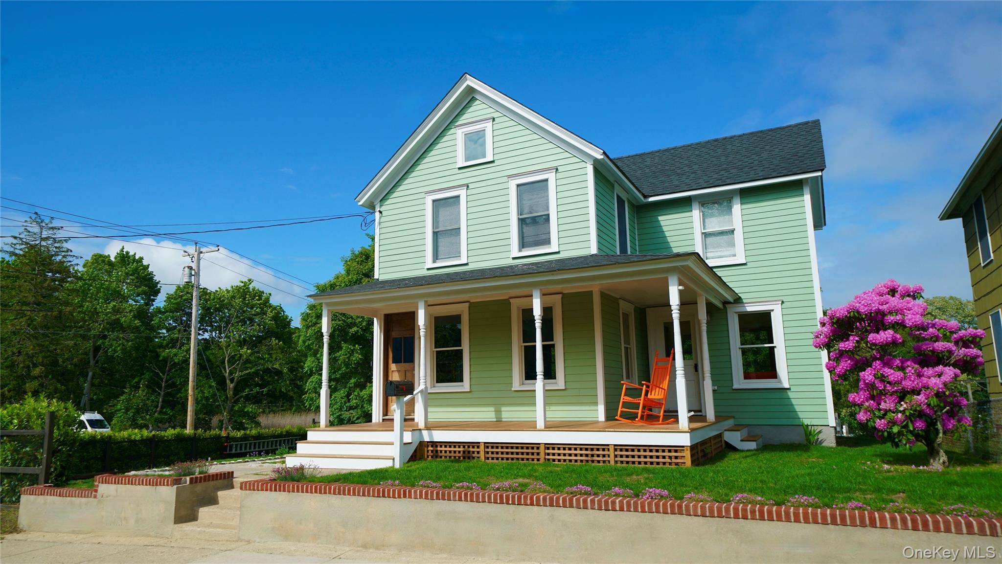 Discover this meticulously renovated 3 bedroom, 2 bath corner property in charming Greenport, offering captivating water views and an expansive, beautifully landscaped garden.