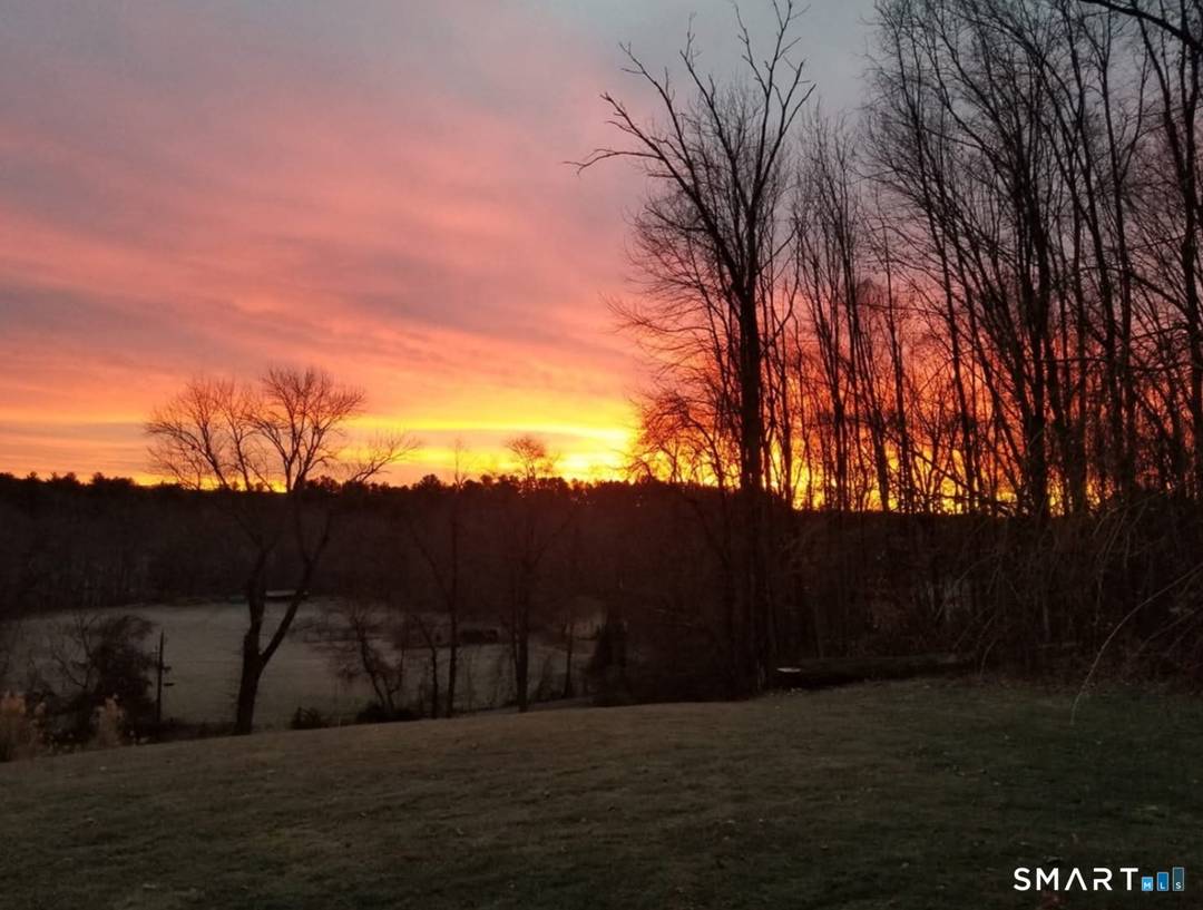 Perched on a hilltop in the scenic countryside of Brooklyn, this stylish custom Cape offers beautiful sunrise views from the inviting front porch.