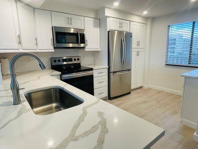 Beautifully updated, light and bright 2 bedroom, 2 bath condo with lovely tranquil lake views.