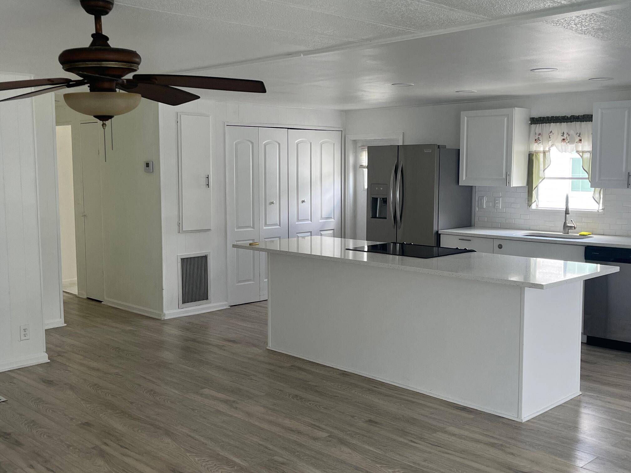 Welcome to this inviting 2 bedroom residence featuring a spacious open floor plan, complete with quartz countertops and elegant white shaker cabinets in the kitchen, complemented by stainless steel appliances.