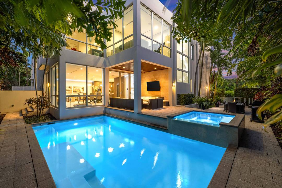 Modern corner lot home built by JH Norman and designed by George Brewer Architects, with soaring ceilings, walls of glass, and a seamless indoor outdoor flow to a pool, spa, ...