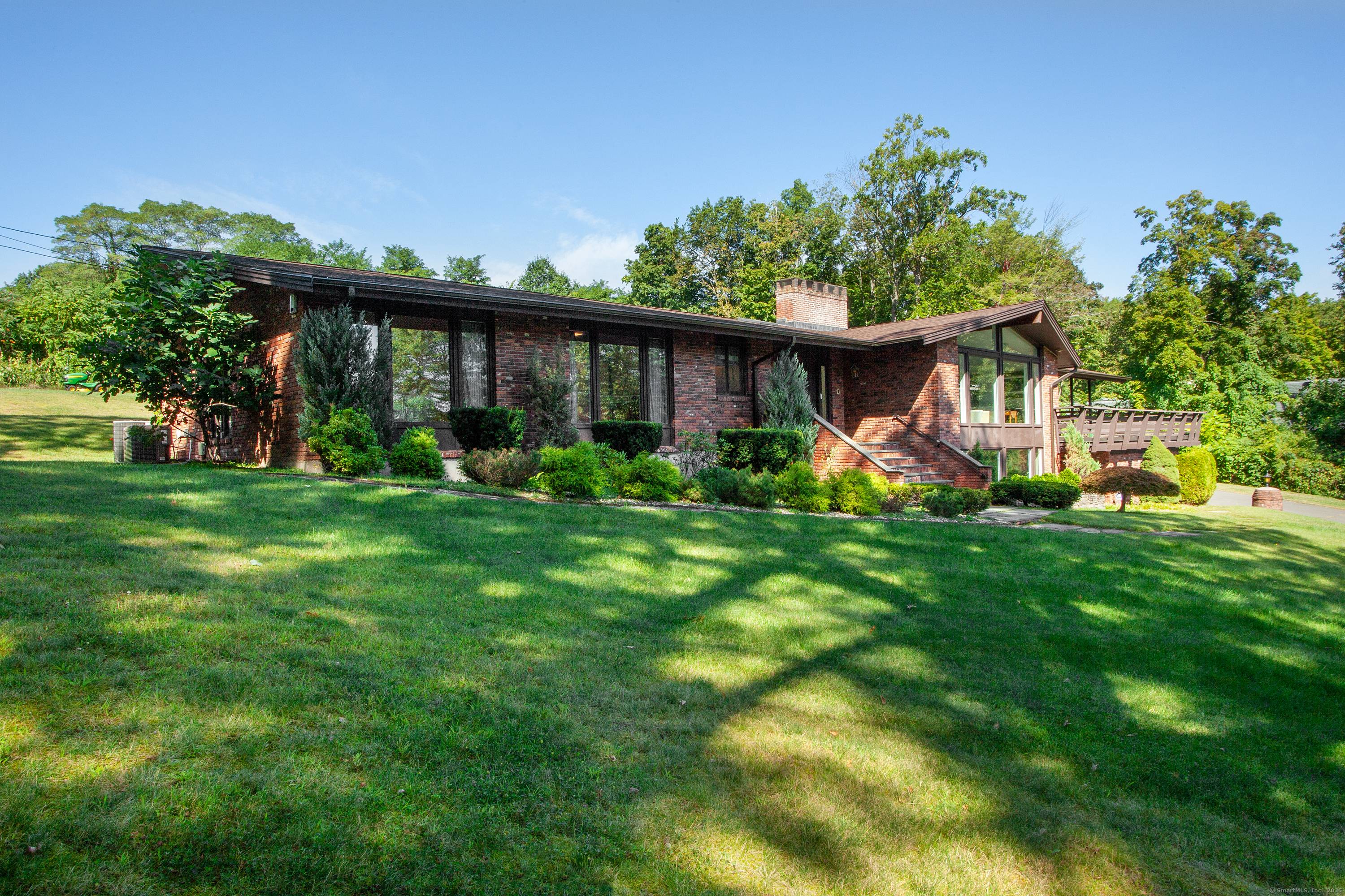 This fabulous contemporary ranch is light filled and ideally situated on an acre lot at the end of a quiet cul de sac !