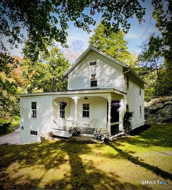 Renovated c. 1860 cottage set along the East Aspetuck River in the heart of historic New Preston.