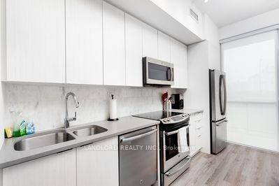 Professionally Managed 1Bed, 1 Bath Suite Showcasing A Sleek Modern Kitchen With Stainless Steel Appliances, Stone Countertops, And Tile Backsplash, Bright Open Concept Living And Dining With Walkout To Private ...