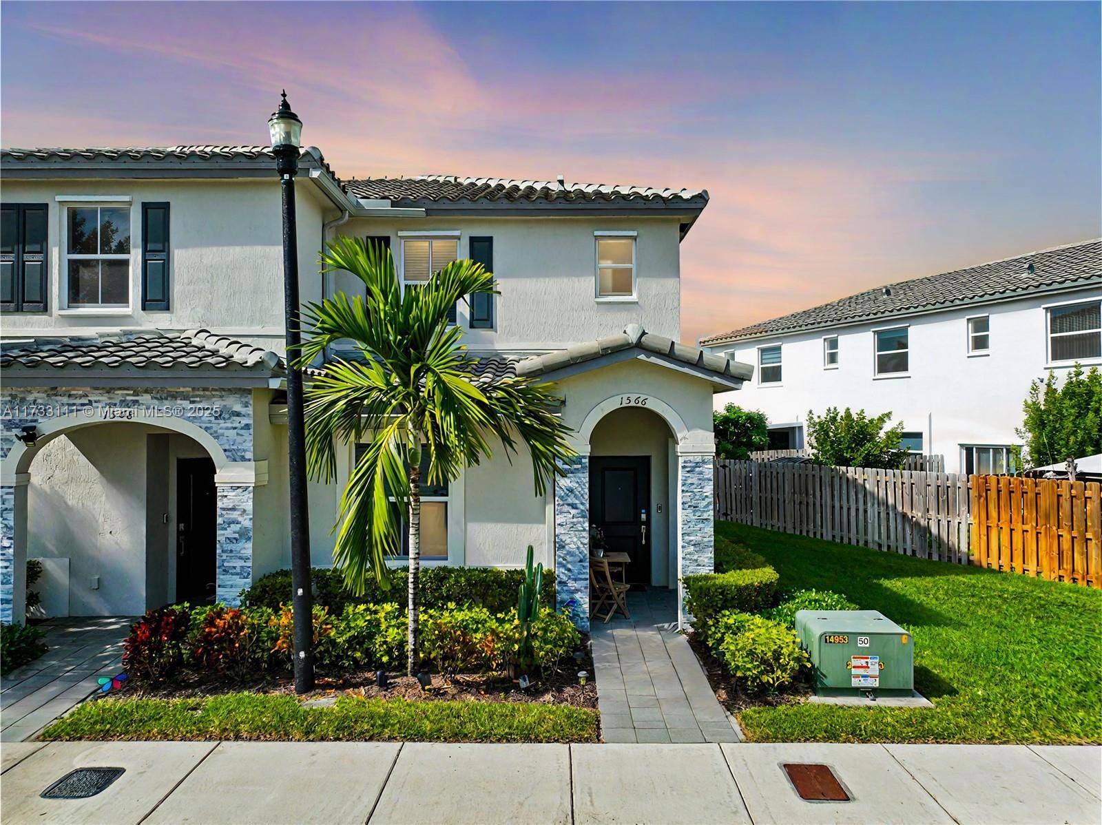 Stunning Town home on a prime corner lot in the sought after Riviera of Keys Gate community.
