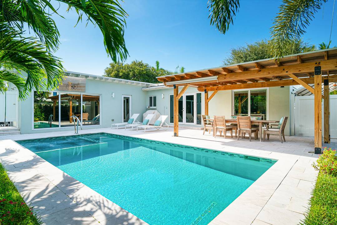 Mid Century Modern Charmer in coveted SoSo ; east of Olive Avenue on a desirable through street to the Intracoastal Waterway.