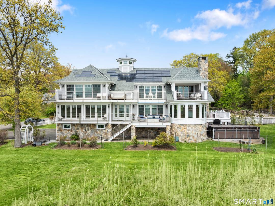 Located in Stamford's Cove neighborhood, this exceptional waterfront residence combines striking architecture, high end construction, and sweeping water views from nearly every room.