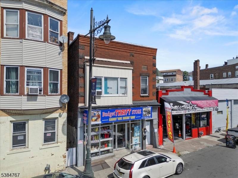 Versatile mixed use property featuring two residential apartments and a commercial storefront.