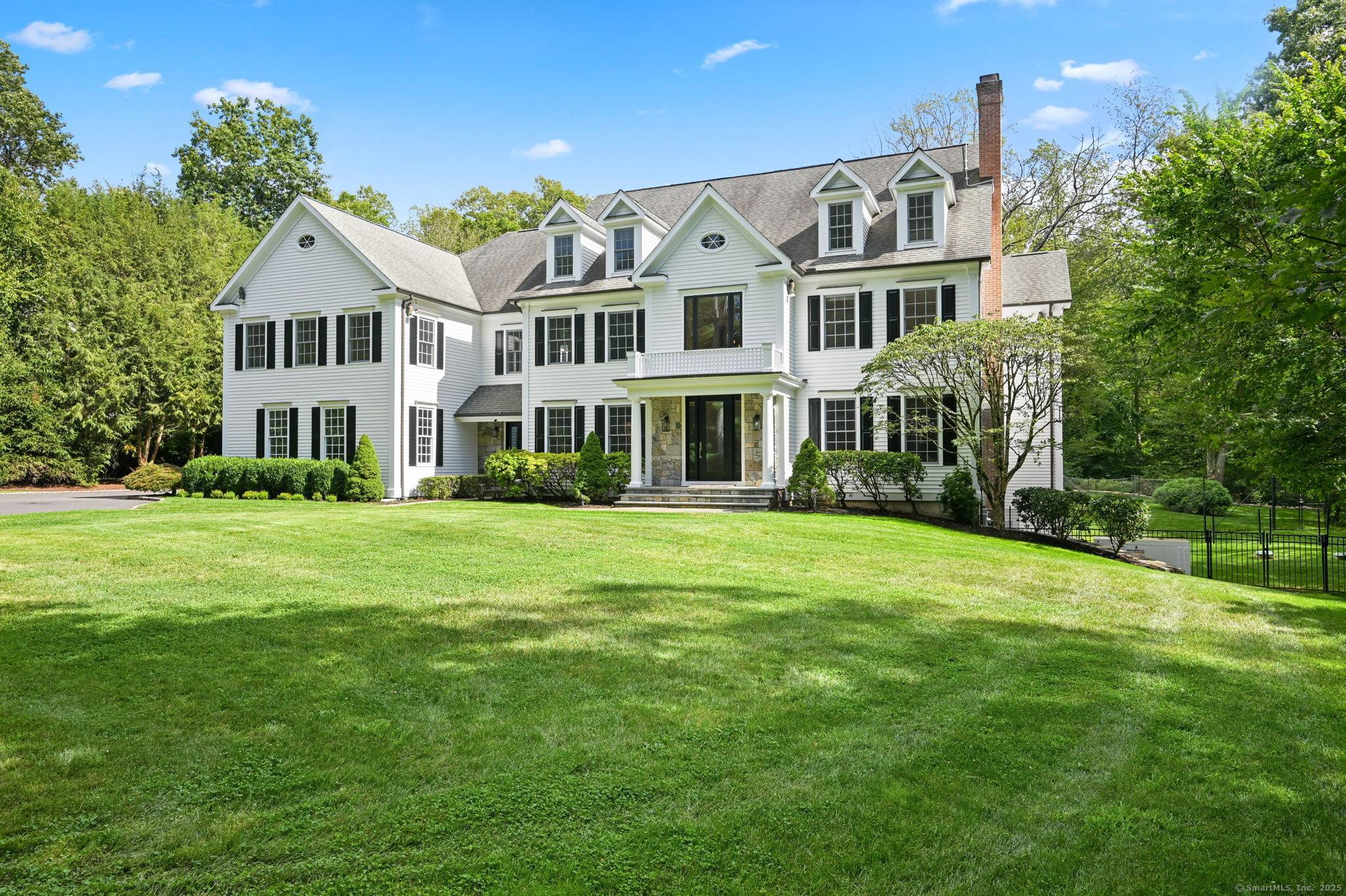 Set on 2. 28 beautifully landscaped acres in a premier neighborhood, this stunning Colonial showcases custom millwork, soaring windows, and sun filled spaces throughout.