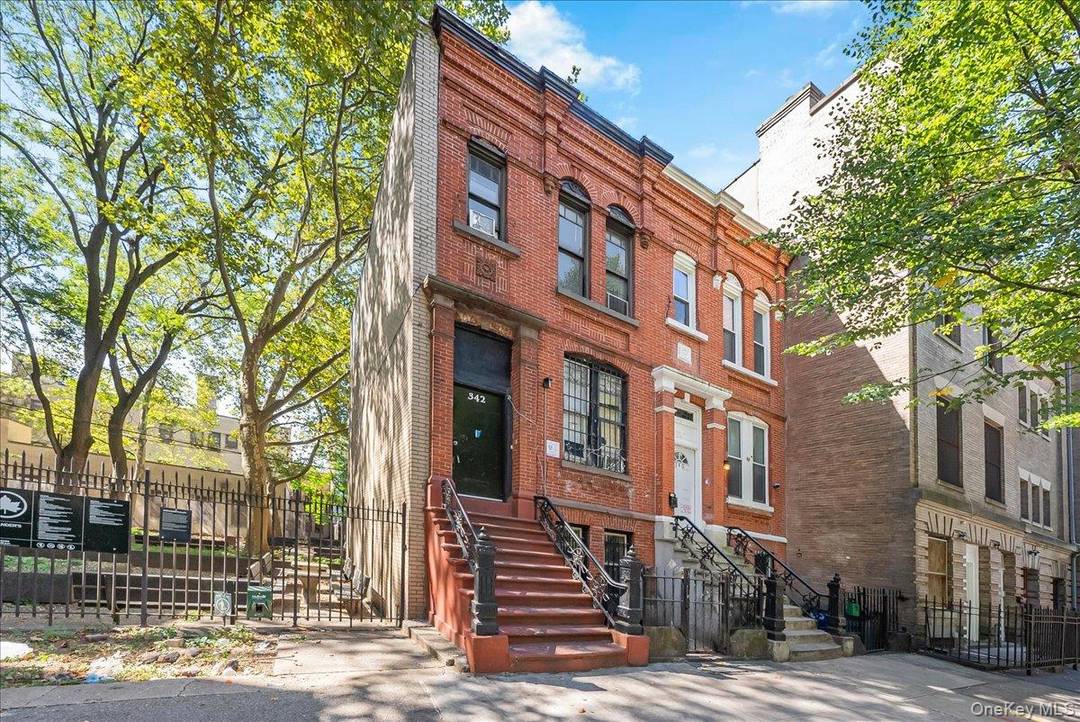 This brick semi attached two family home in Mott Haven is ready for your vision rich with character and history.