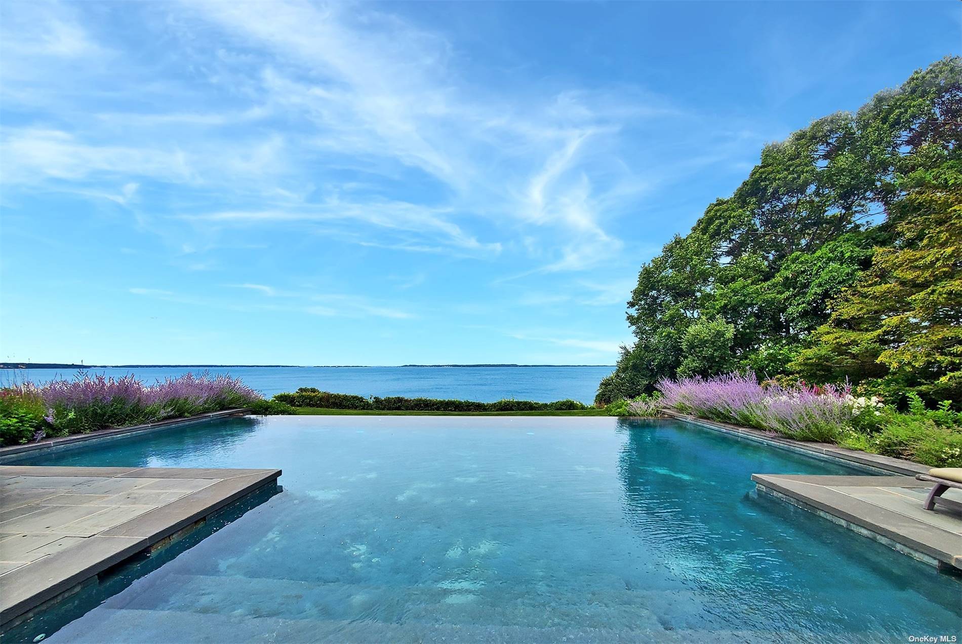 Enter this gated property leading to a magnificent, shingled style masterpiece.