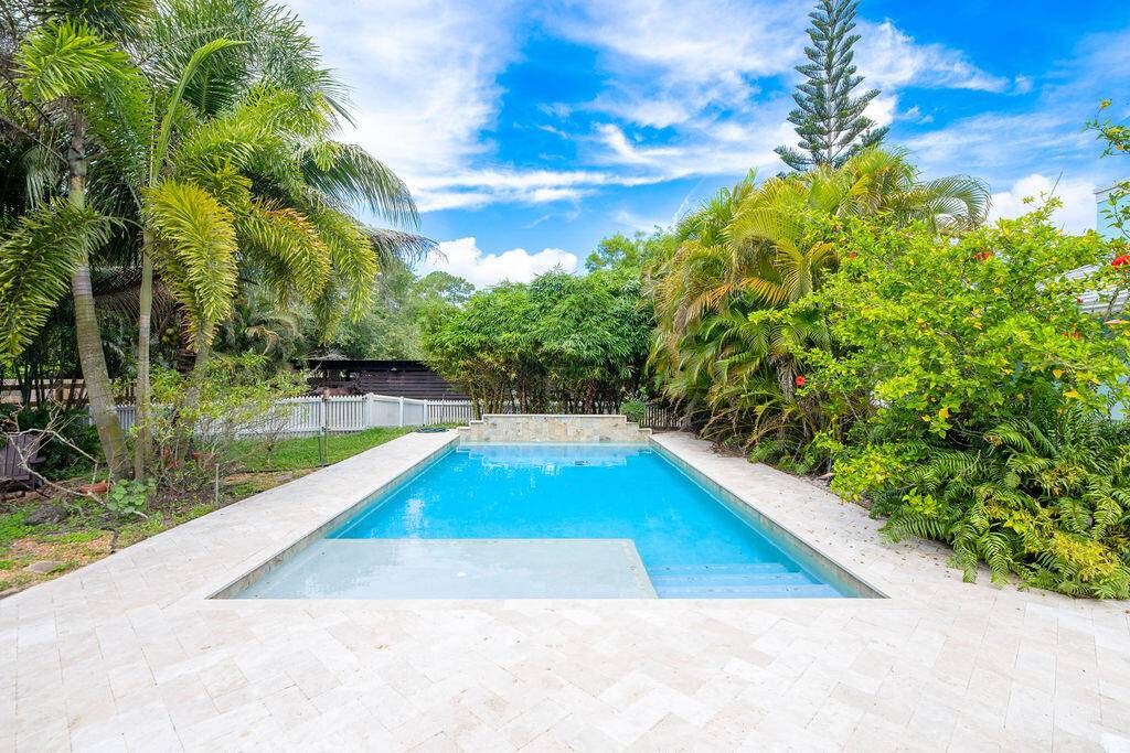 Experience the best of both worlds with this beautifully maintained pool home in Jupiter Farms offering peaceful country living just minutes from all the conveniences of town.