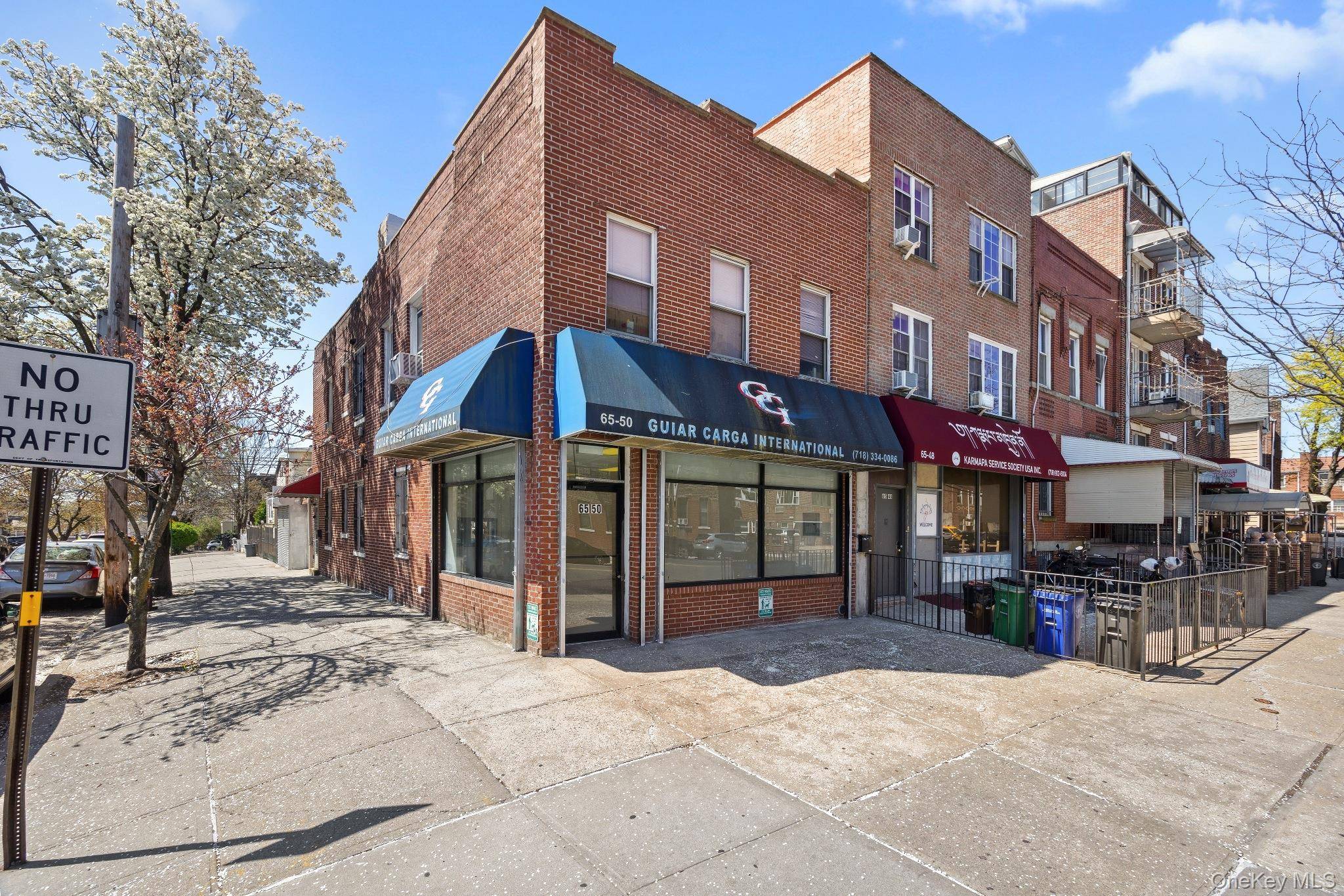 Woodside corner mixed use building for sale.