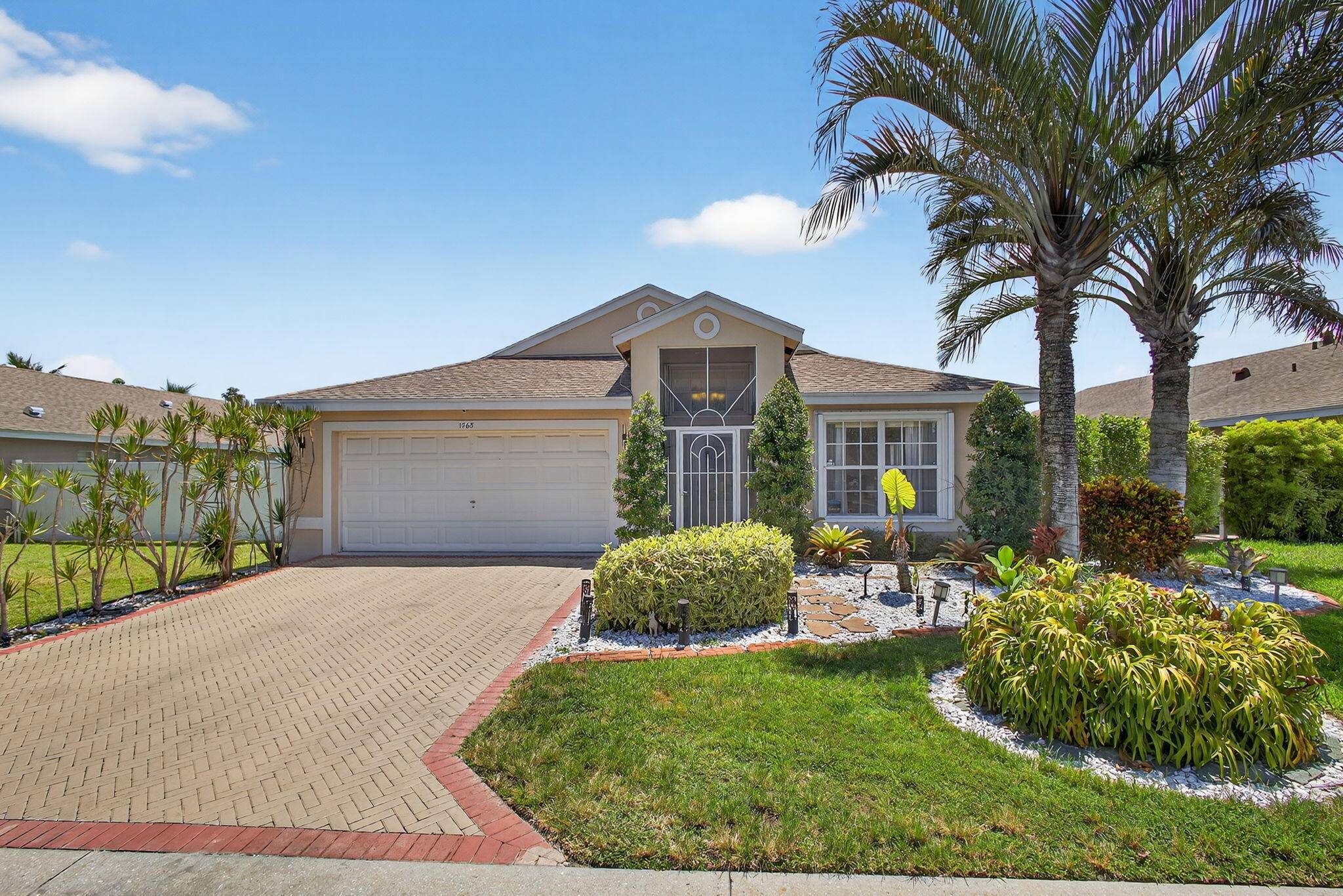 BRAND NEW ROOF 2024 ! ! Stunning lakefront home with 3 bedrooms, 2 baths, a 2 car garage, screened in pool and spa, and low HOA fee.