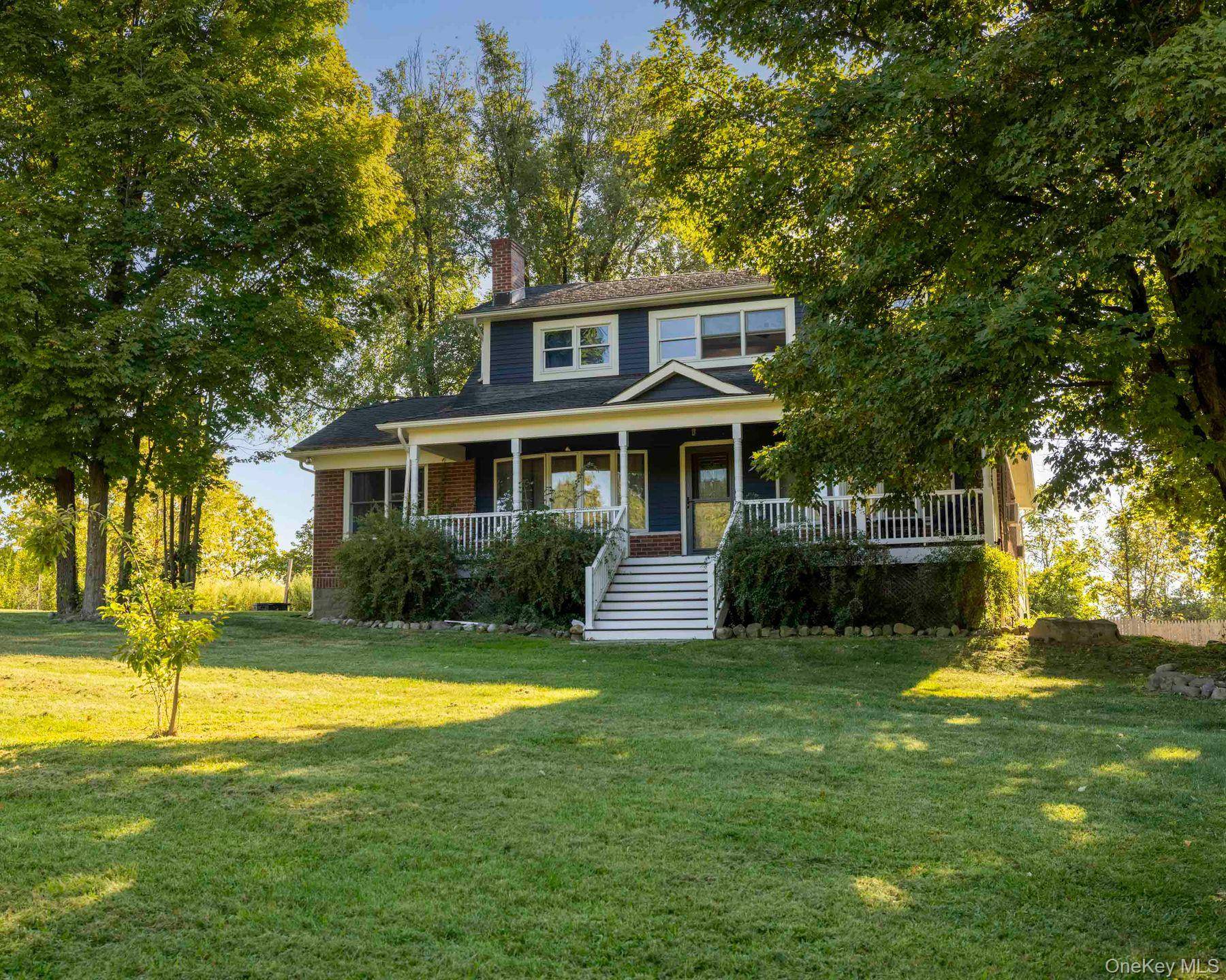 This charming 1900 farmhouse in Highland, New York, offers a comfortable and spacious living space with original wide custom moldings and beautiful oak hardwood flooring.