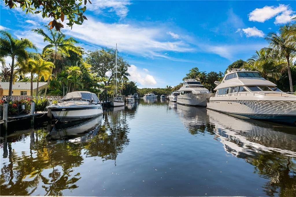 Discover waterfront paradise in this FULLY REMODELED home, set on a spacious 1 2 acre lot with 50 feet of water frontage.