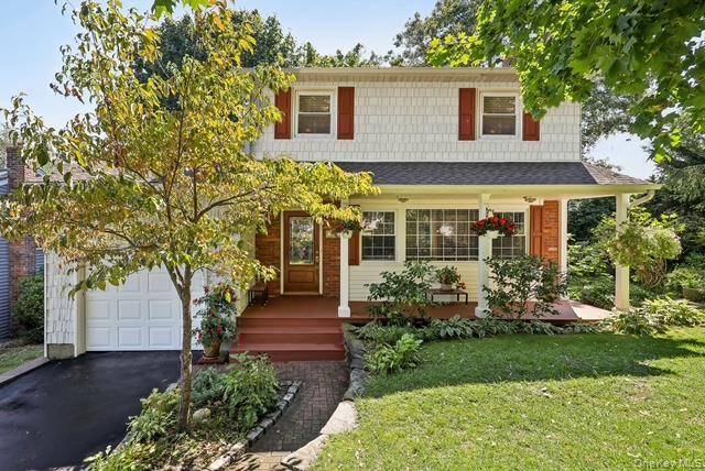 Lovely Light Filled Colonial with Views of the Private Setting !