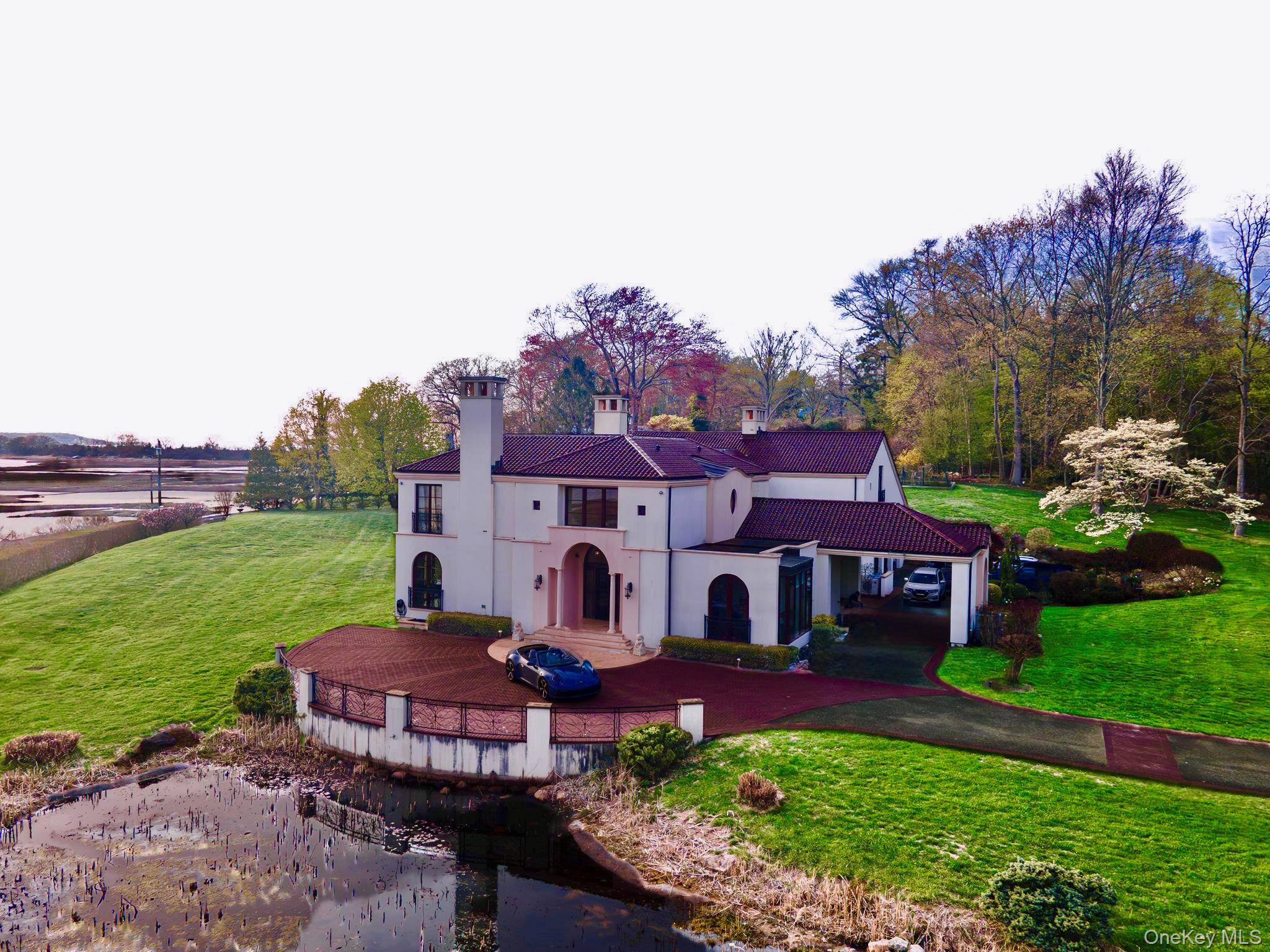 Experience timeless architecture and peaceful luxury in this Feng Shui inspired estate nestled within the prestigious Short Beach enclave of Nissequogue.