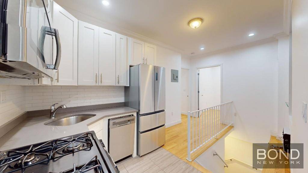 Renovated 2 bedroom duplex with a large Living room rec room on the lower level, a laundry room, separate kitchen, stainless steel appliances, dishwasher, microwave, hardwood floors and high ceilings.