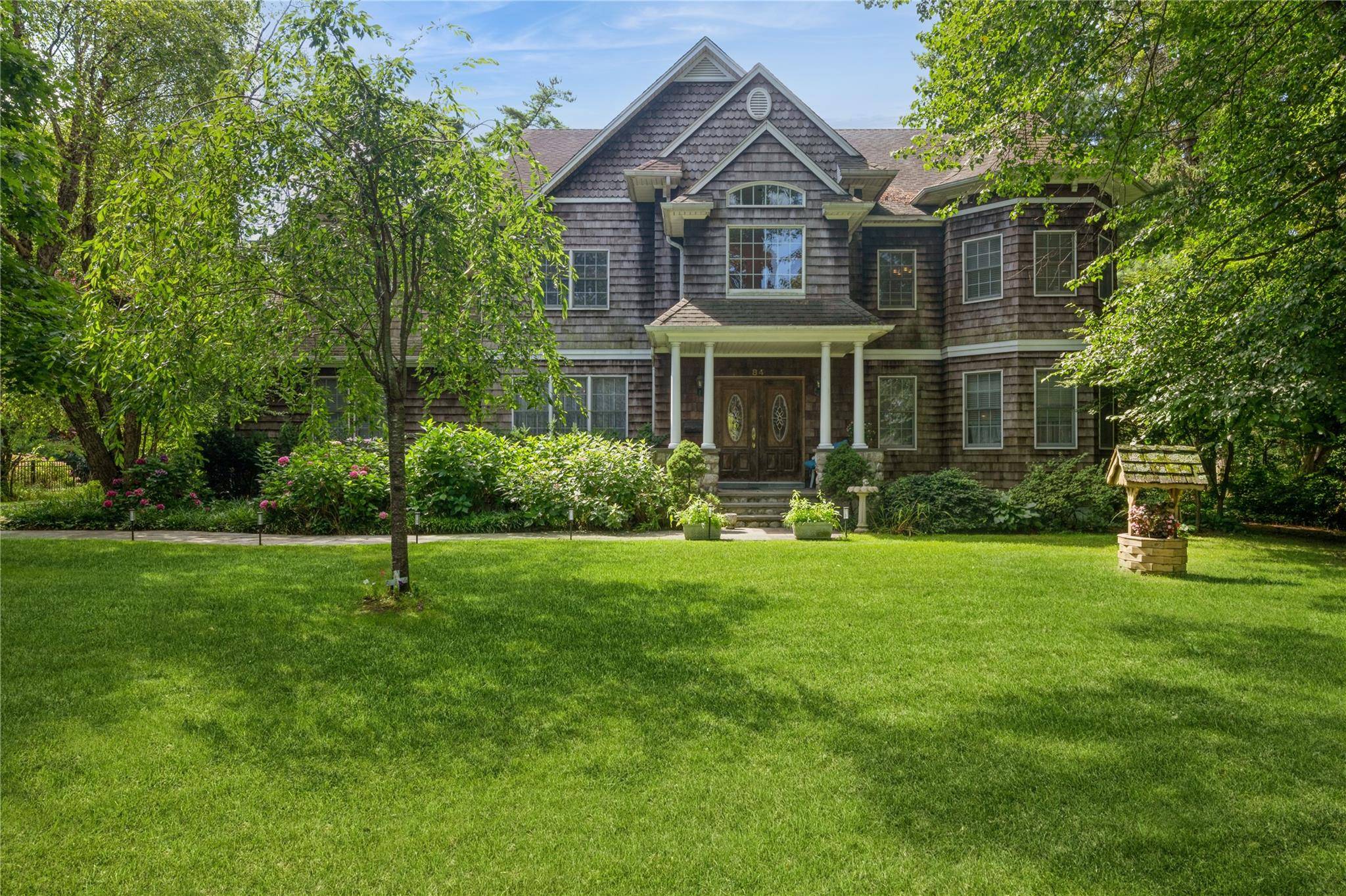 Located in Garden City s Central Section, this impressive five bedroom, five bath home offers 4, 106 sq.