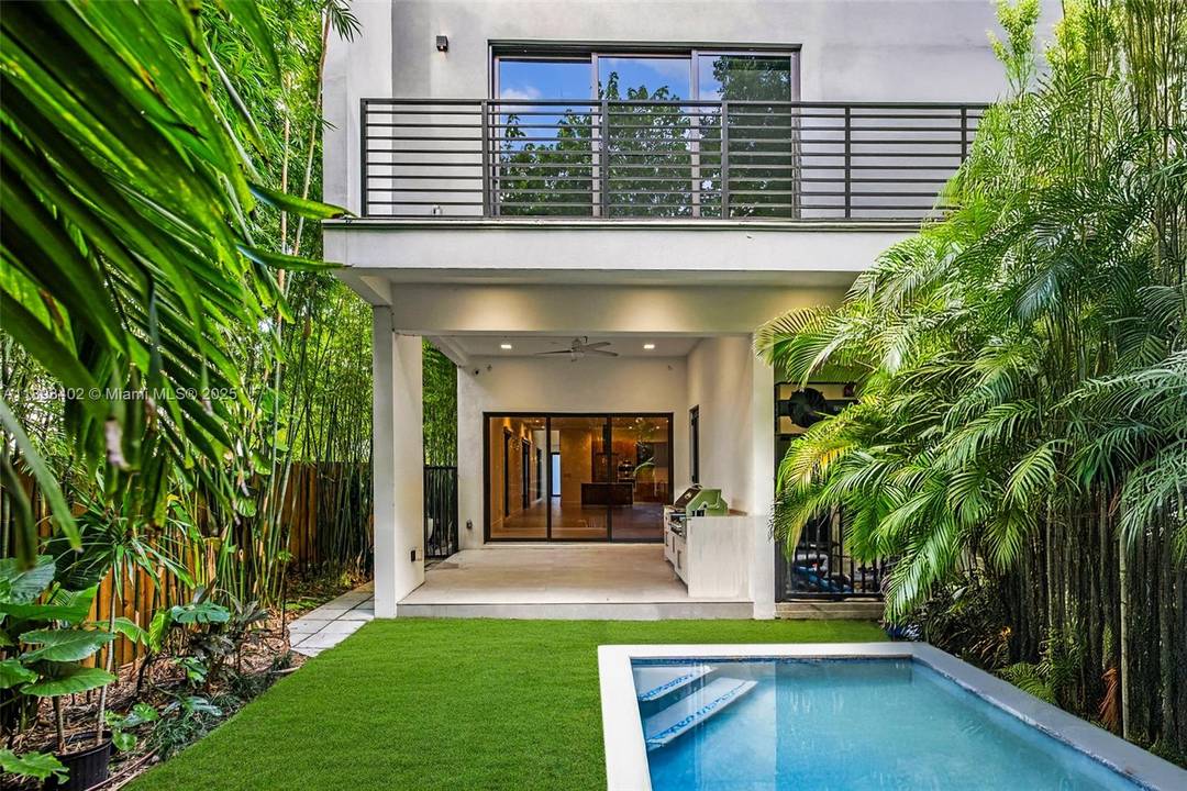 Luxury Coconut Grove living awaits in this 2022 built 4BD 5BA modern home designed for seamless indoor outdoor living.