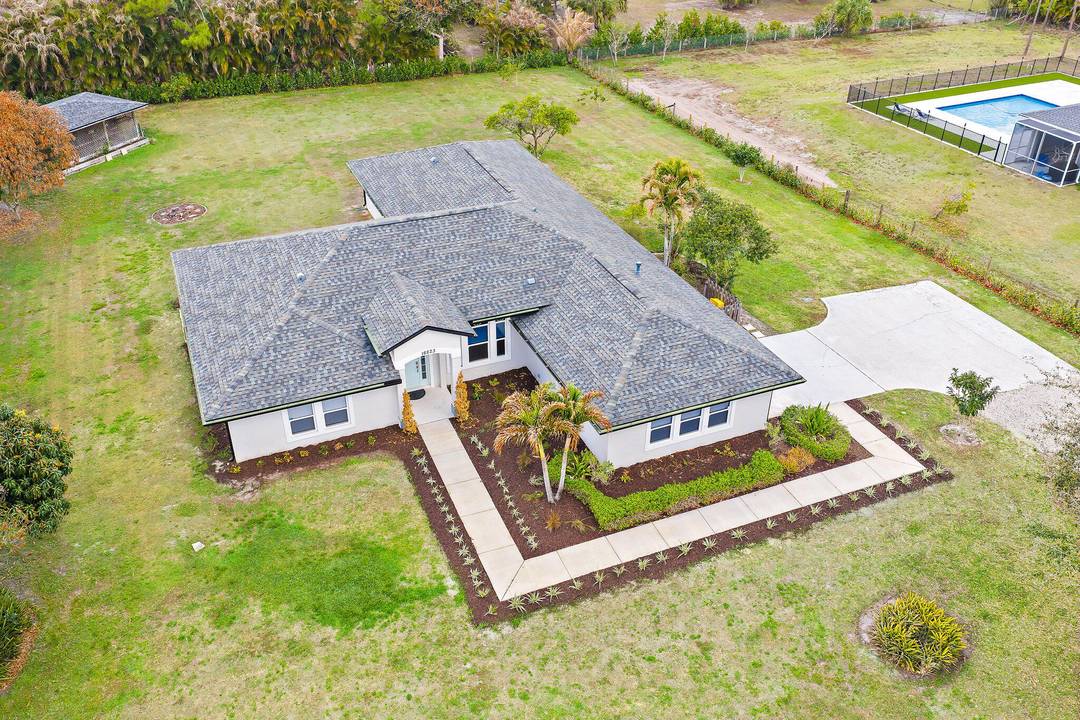 5 bedroom, 3 bathroom home in Jupiter Farms situated on a spacious lot with no HOA, offering a single story layout designed for both everyday living and flexibility.