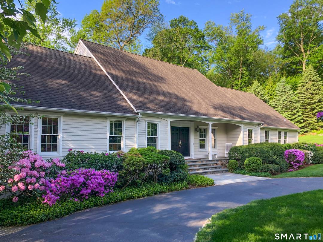 Exceptional New England Cape Cod architecture, beautifully sited on a coveted Ridgefield cul de sac.
