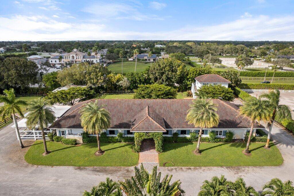 This exceptional gated 4 acre horse farm in Wellington offers the ideal setting for equestrian enthusiasts, with impeccable landscaping and a prime location just a true 5 minute hack from ...