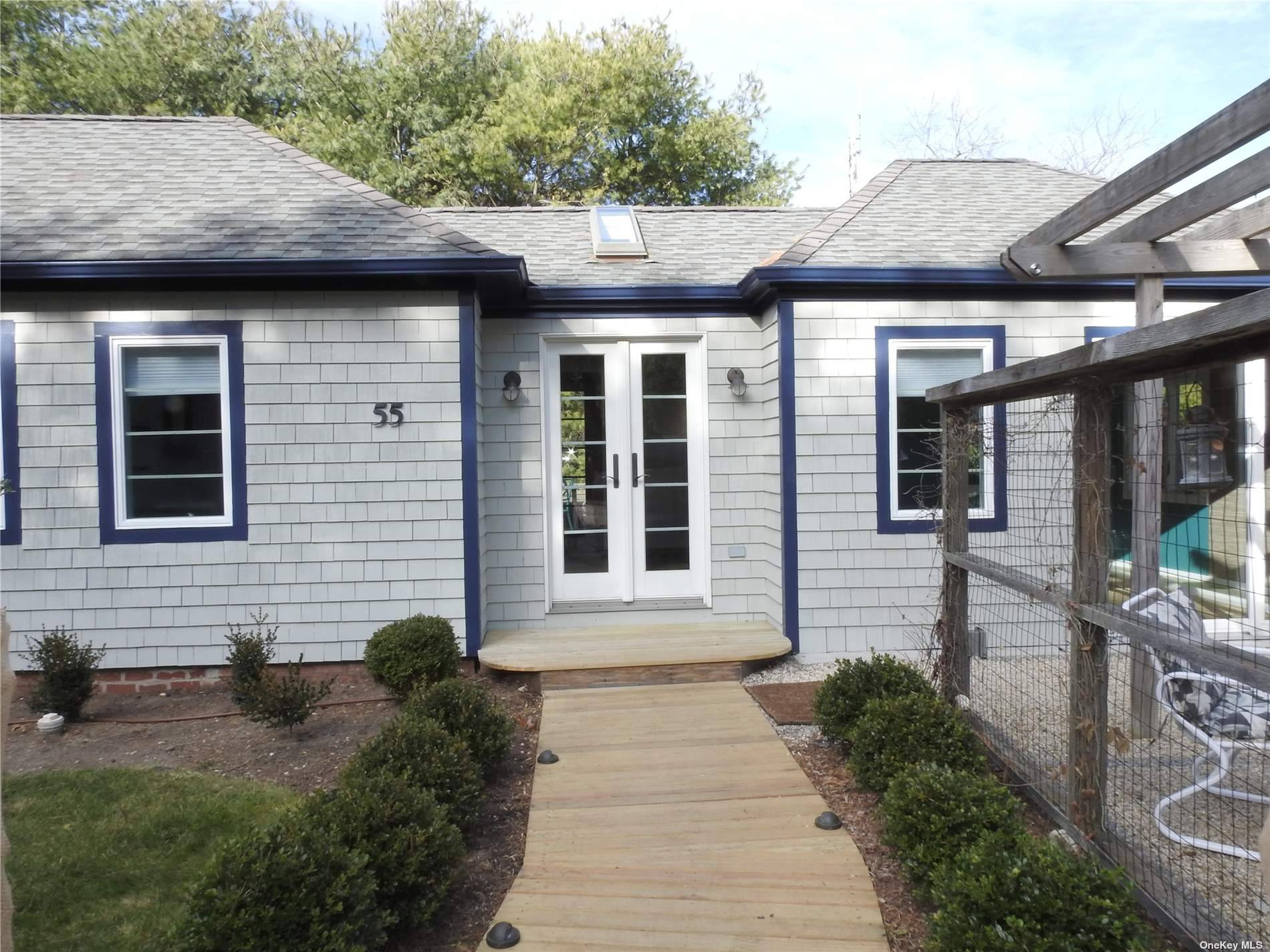 Quintessential 800 sq ft two bedroom, one bath Cottage on a private wooded lot with backyard deck and front yard patio.