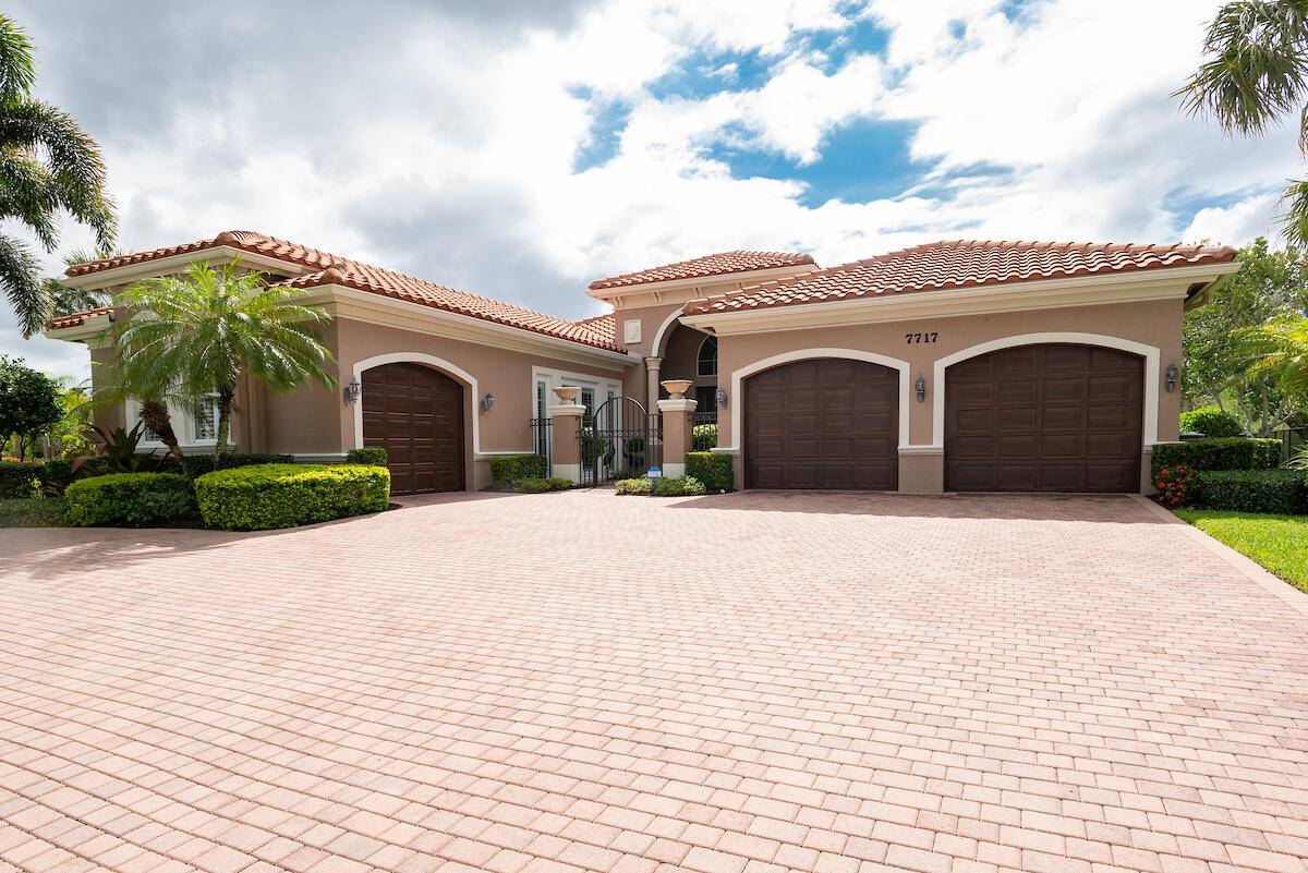 7717 Eden Ridge Way is set on a half acre lot on a quiet cul de sac which is surrounded by beautiful lakes and preserves in Palm Beach Gardens.