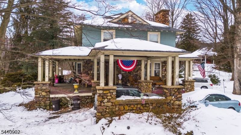 Nestled in the heart of Town Center on approximately 2 acres, this historic farmhouse offers timeless character and breathtaking views of Pinecliff Lake.