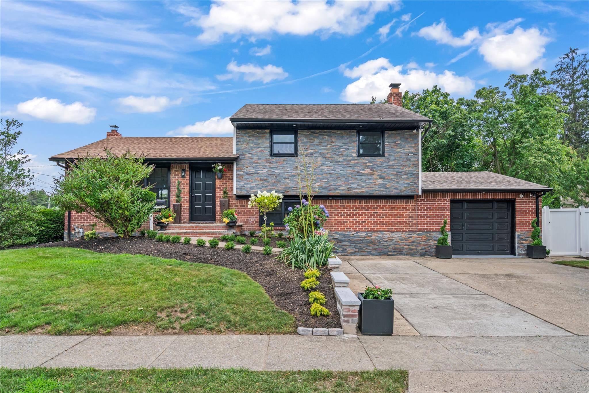 JERICHO. An outstanding opportunity to purchase a recently renovated 3 Bedroom Den and Office Charming Split Level home on an incredible corner lot within Jericho.