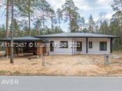 A One story residential house with carport for two cars newly established village of Marsilli, Latvia.