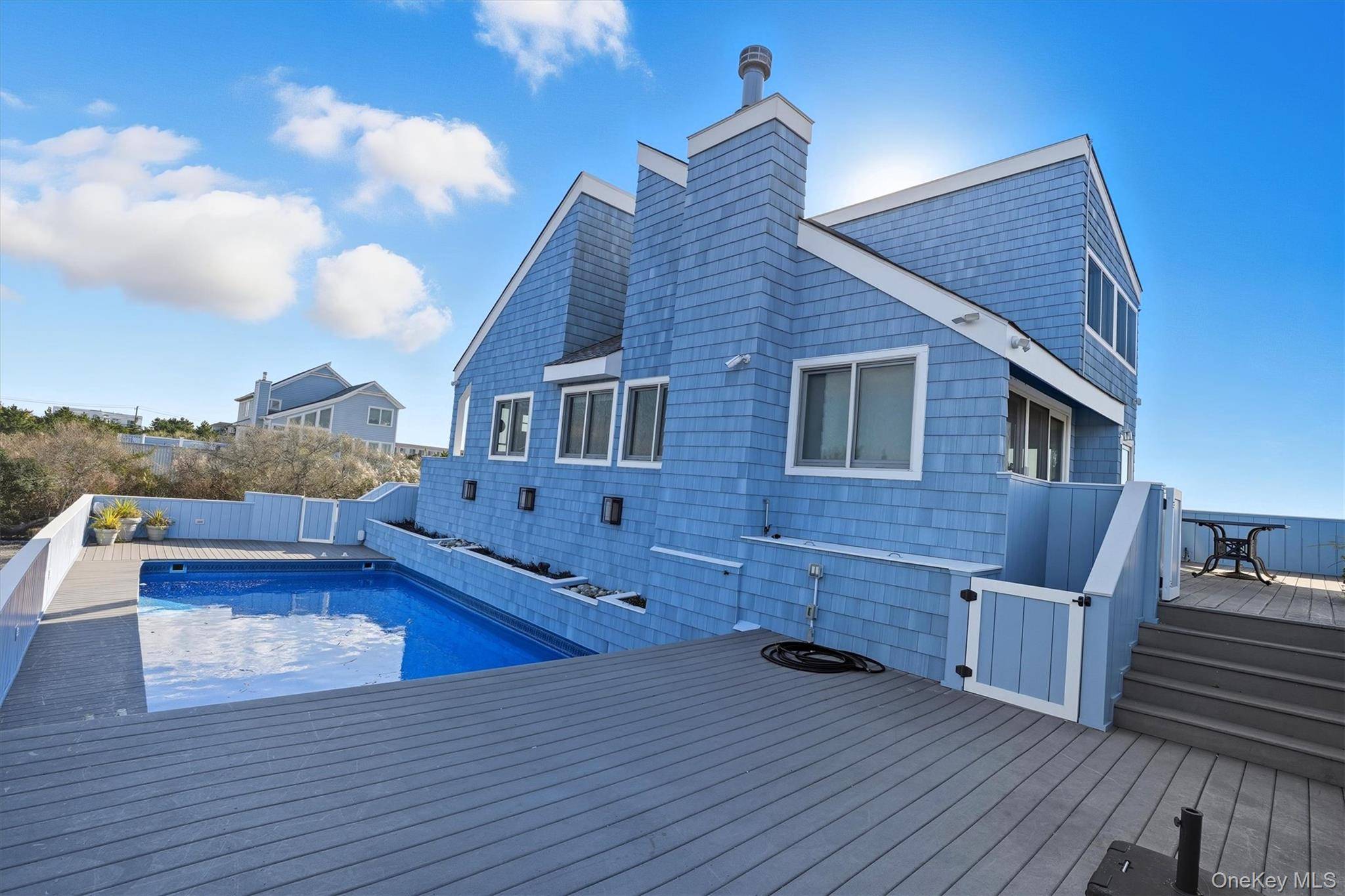 Views, Views, Views ! Experience contemporary coastal living at its finest in this pristine waterfront home on coveted Dune Road in Westhampton.
