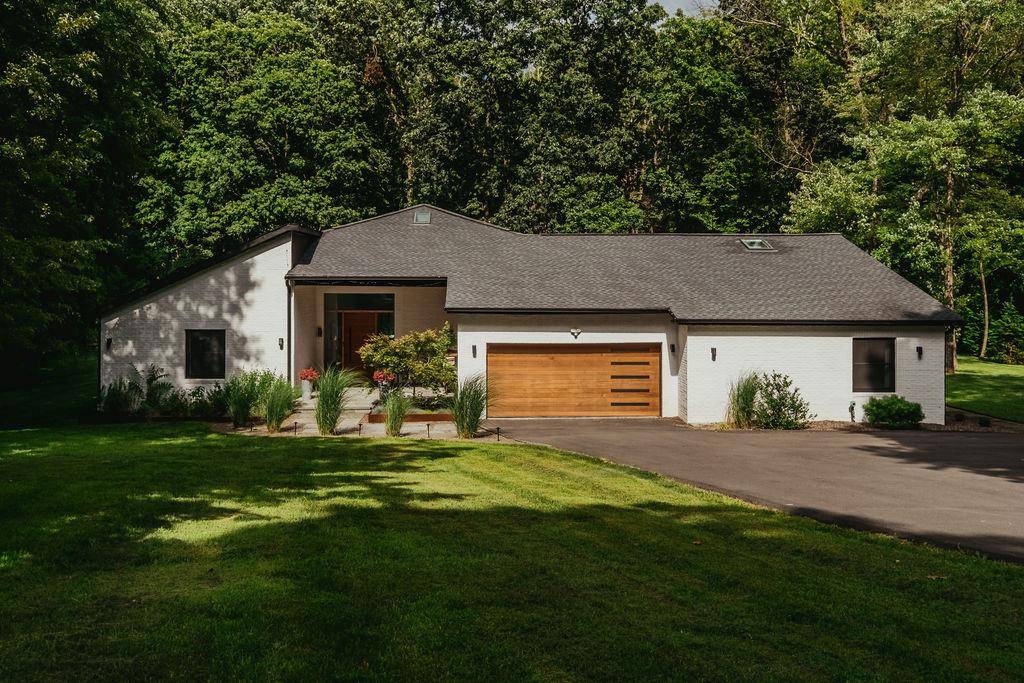1 mile from Rhinebeck s vibrant village, this home sits on a hushed, leafy road.