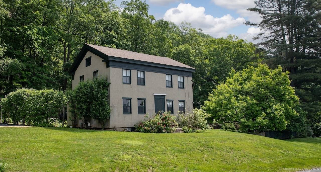 Set on a quiet road in Falls Village, Connecticut, this enchanting 1790s Irish inspired farmhouse offers magnificent western views to Falls Mountain and beyond.