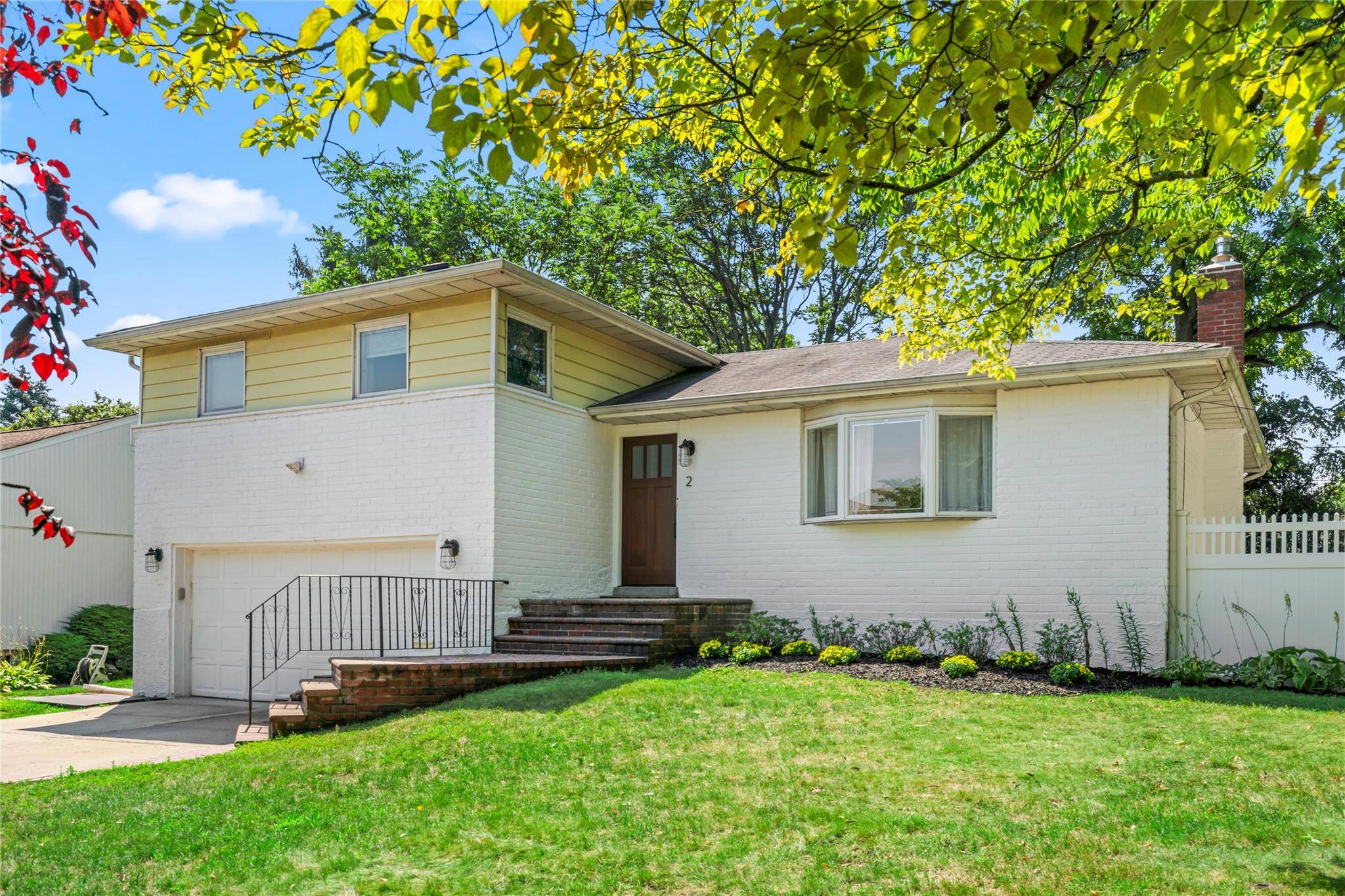 SEARINGTOWN Nestled on an oversized, tree lined corner lot in the heart of Searingtown, this beautifully updated brick and siding split level home offers style, space, and comfort.
