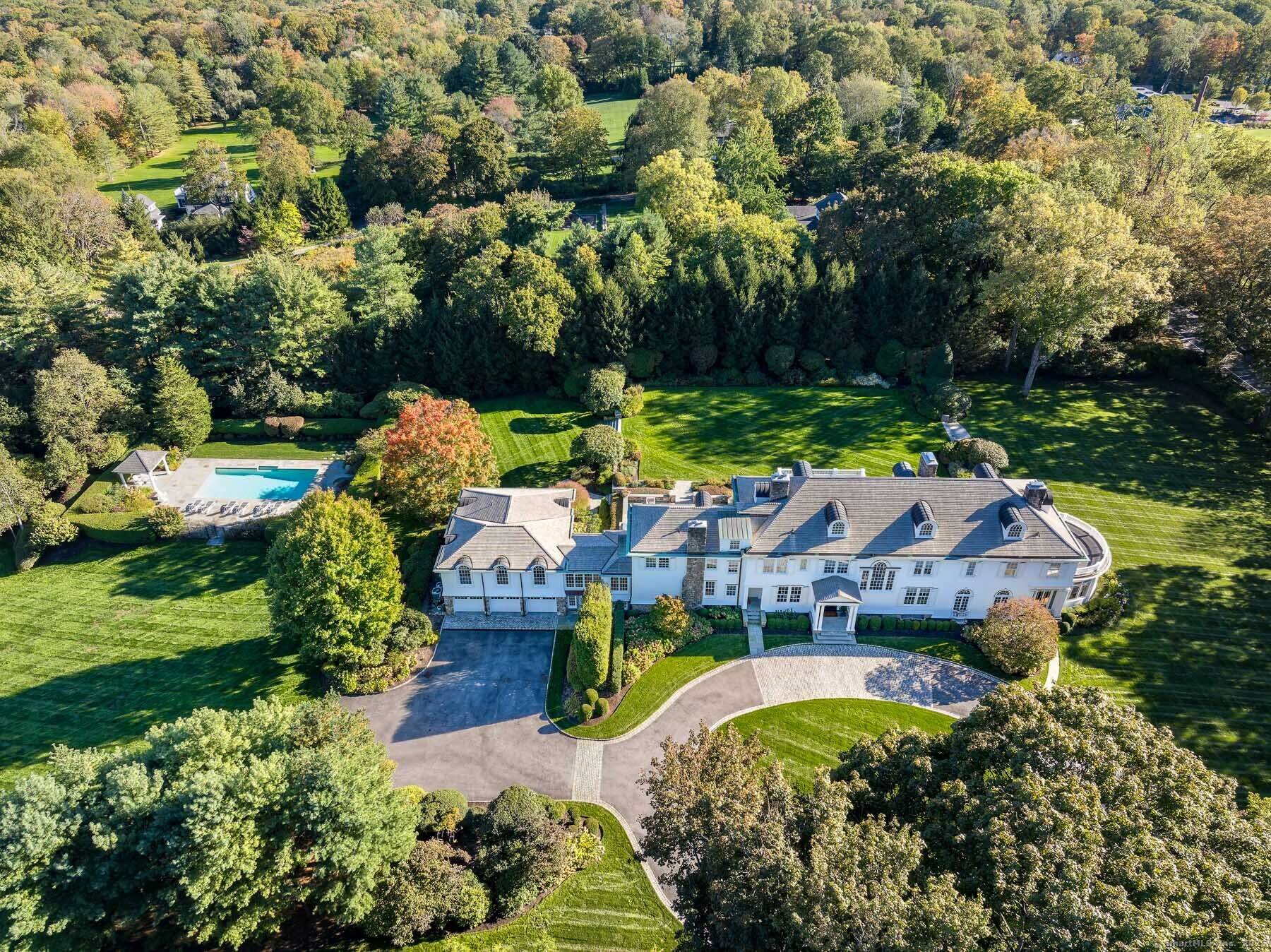 Set on one of New Canaan's highest elevations, this iconic country estate offers a rare combination of architectural distinction, modern functionality, and understated luxury.