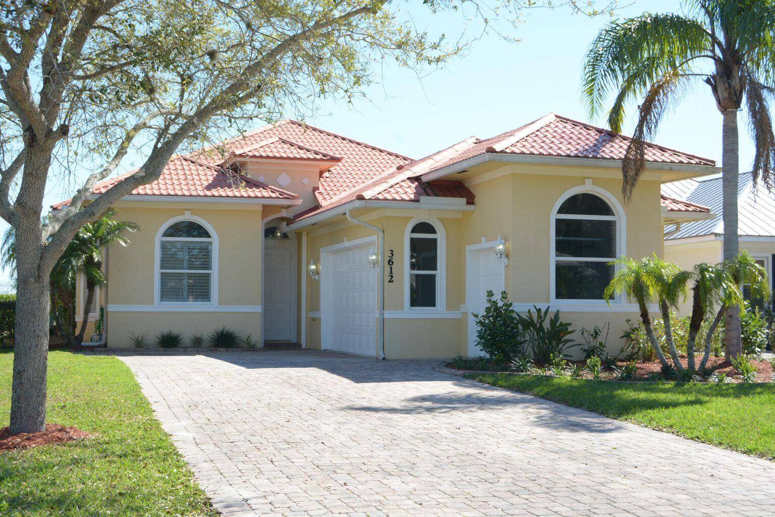 Charming Lakefront 3 2 3, home with golf cart bay situated in the prestige gated Meadowood Country Club golf community.