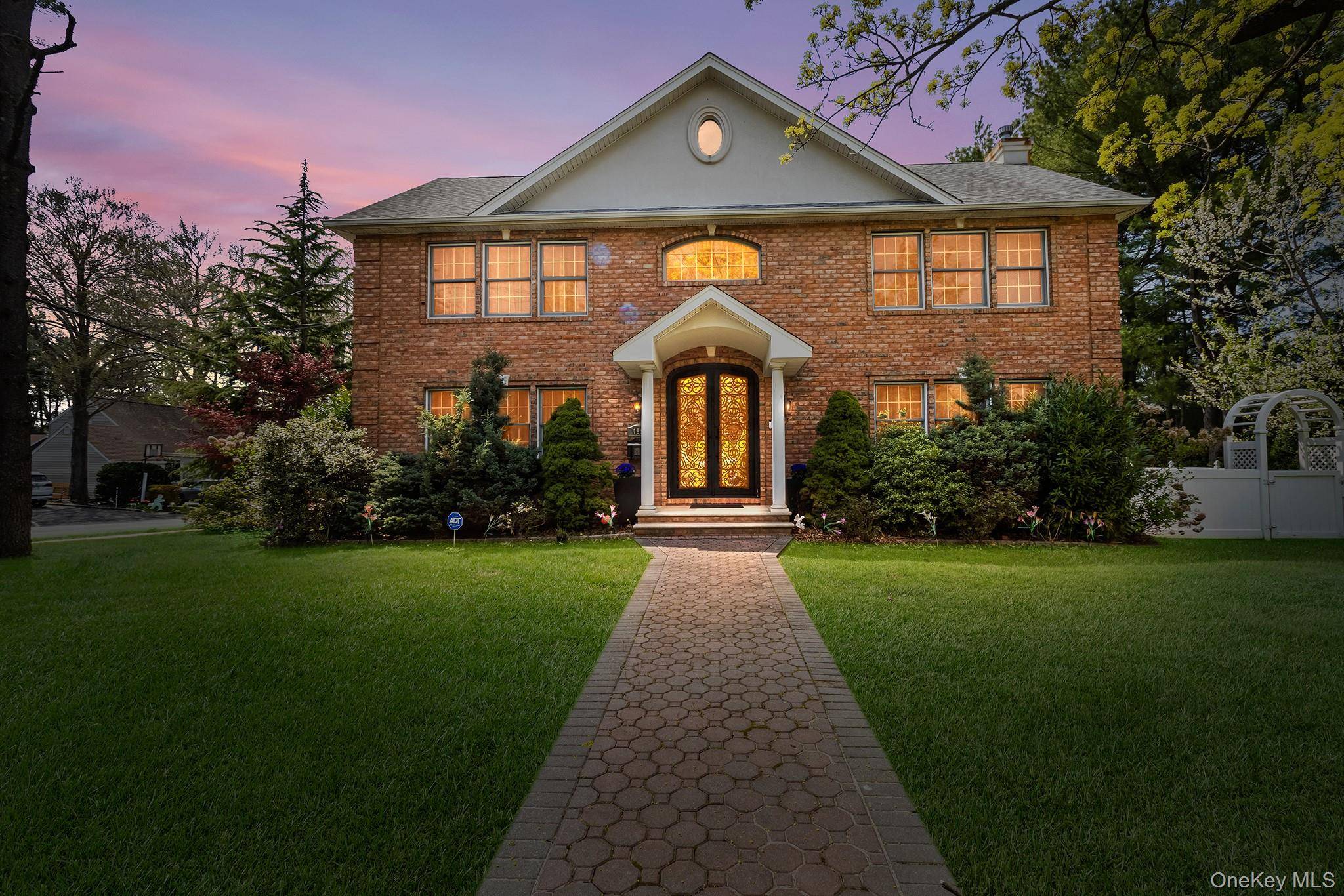 Welcome to this stately brick center hall Colonial nestled in East Williston.